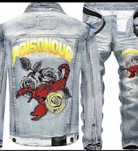 a denim jacket with a red rose on it