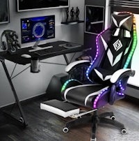 a gaming chair with lights and a monitor