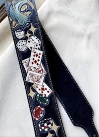 a guitar strap with poker chips and cards on it