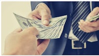 a businessman handing out money to another person