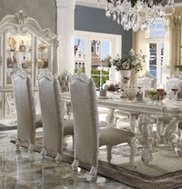 an ornate dining room set with a chandelier
