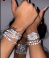 a woman wearing a bracelet with diamonds on it