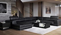 a black leather sectional sofa in a living room