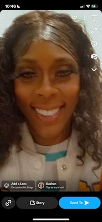 a woman's face is shown on the screen of an iphone