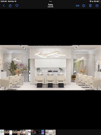 a photo of a salon with chairs and tables
