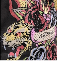 a black t - shirt with a tiger and roses on it