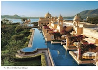 a hotel in rajasthan with a pool and a lake